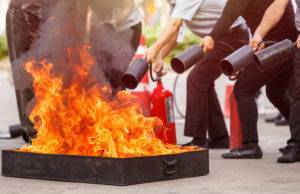 people in the conflagration preventive extinguisher training program, Safety concept. Focus on fire tray